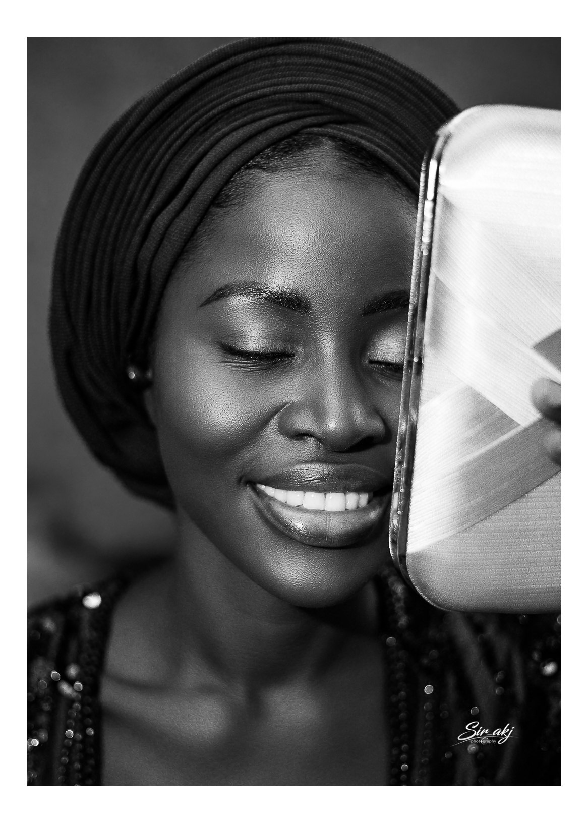 A smiling woman in a black and white portrait